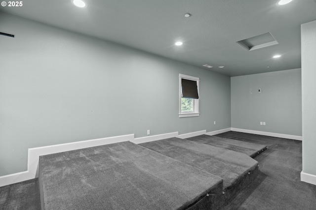 unfurnished room featuring dark carpet