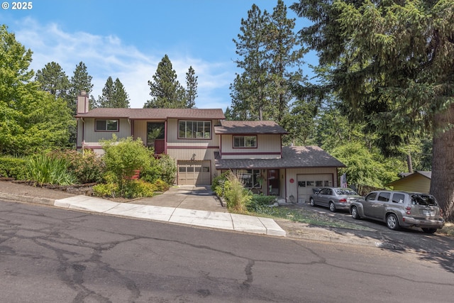 505/515 Empress Ave, Eugene, OR 97405 - view of front of house with a chimney, driveway, an attached garage, and a shingled roof