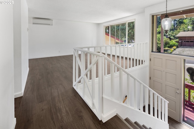 505/515 Empress Ave, Eugene, OR 97405 - hallway featuring an upstairs landing, a wall mounted air conditioner, and dark wood-style flooring