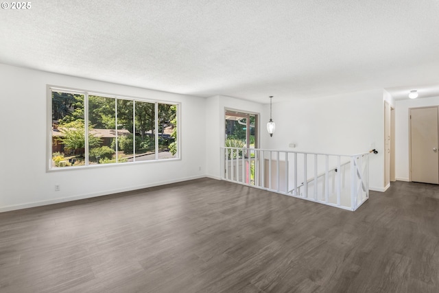 505/515 Empress Ave, Eugene, OR 97405 - spare room with a textured ceiling and dark wood finished floors