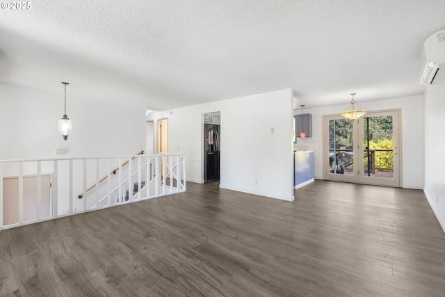 505/515 Empress Ave, Eugene, OR 97405 - spare room featuring dark wood-style flooring, a wall mounted air conditioner, and a textured ceiling
