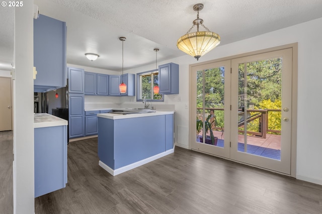 505/515 Empress Ave, Eugene, OR 97405 - kitchen with blue cabinetry, light countertops, dark wood-style floors, and a textured ceiling