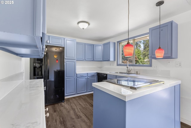 505/515 Empress Ave, Eugene, OR 97405 - kitchen with black fridge, dark wood-type flooring, blue cabinets, a peninsula, and light countertops