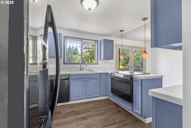 505/515 Empress Ave, Eugene, OR 97405 - kitchen featuring black electric range oven, blue cabinets, freestanding refrigerator, and dark wood finished floors