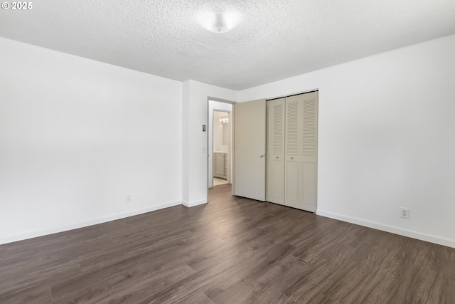 505/515 Empress Ave, Eugene, OR 97405 - unfurnished bedroom featuring dark wood finished floors, a closet, and a textured ceiling