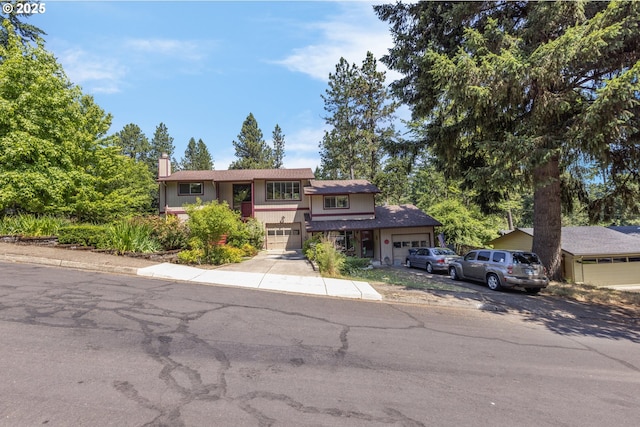 505/515 Empress Ave, Eugene, OR 97405 - view of front of property featuring a garage, a chimney, and concrete driveway