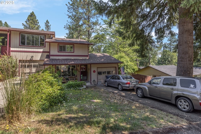 505/515 Empress Ave, Eugene, OR 97405 - split level home with an attached garage, driveway, roof with shingles, and a front lawn