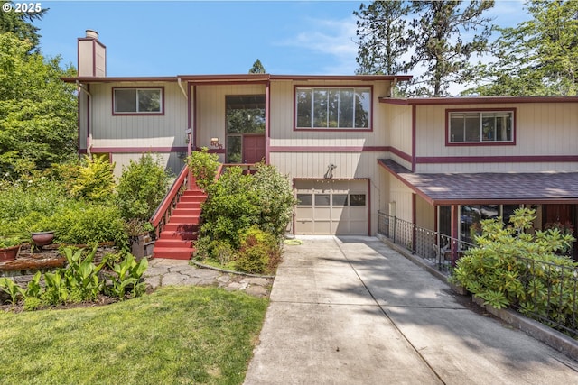 505/515 Empress Ave, Eugene, OR 97405 - view of front of home featuring concrete driveway, a chimney, an attached garage, and stairway