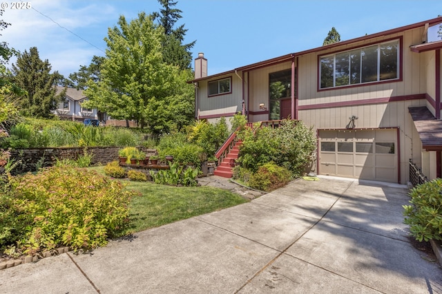 505/515 Empress Ave, Eugene, OR 97405 - bi-level home featuring a chimney, a garage, driveway, and stairs