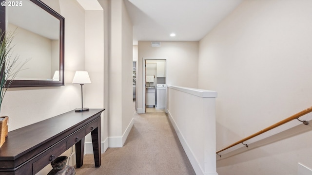 corridor with baseboards, recessed lighting, an upstairs landing, and light carpet