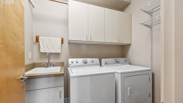 laundry area with a sink, cabinet space, and washing machine and dryer