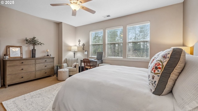 bedroom with visible vents, carpet flooring, and a ceiling fan