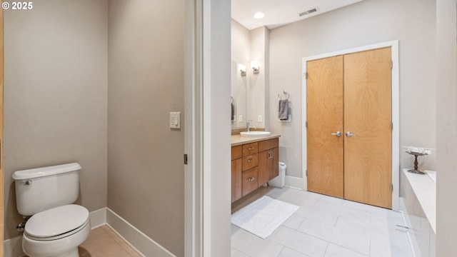 full bathroom featuring tile patterned flooring, vanity, toilet, baseboards, and visible vents