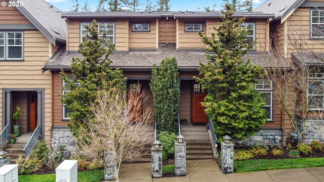 view of front of home with a shingled roof