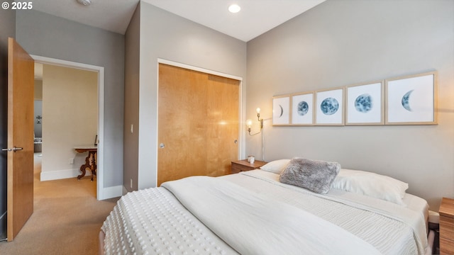 bedroom with carpet flooring, baseboards, and a closet