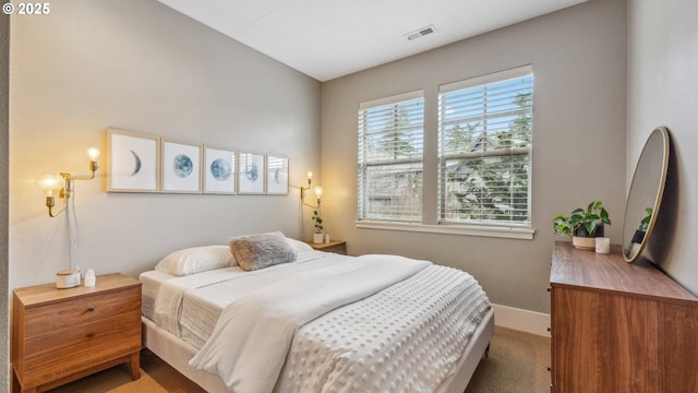 bedroom featuring baseboards, visible vents, and carpet