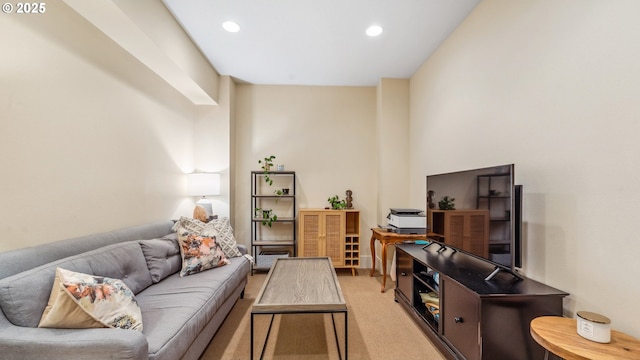 living area featuring light colored carpet and recessed lighting