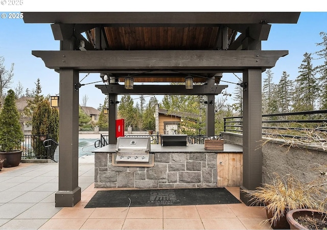 view of patio featuring area for grilling, fence, and exterior bar
