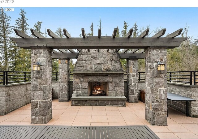 view of patio featuring an outdoor stone fireplace and a pergola