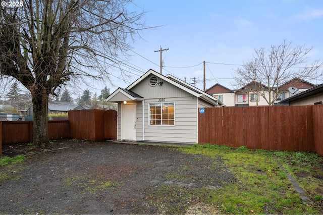 exterior space featuring driveway and fence