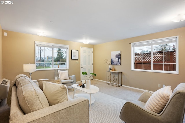 carpeted living room featuring baseboards and a wealth of natural light