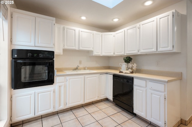 kitchen with light countertops, recessed lighting, white cabinets, black appliances, and a sink