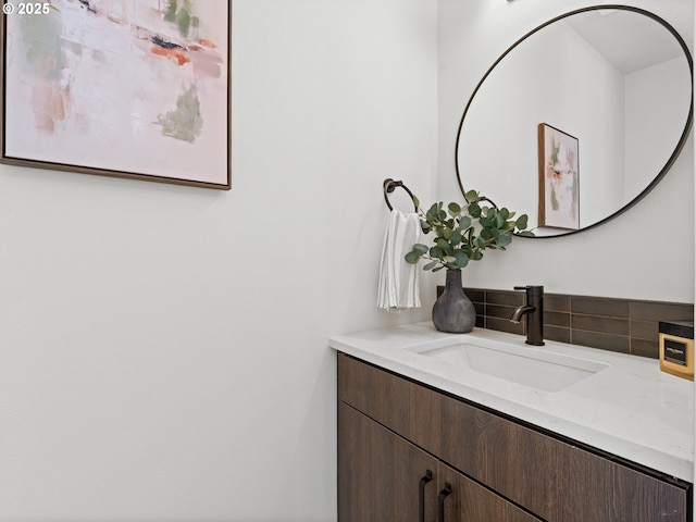 bathroom featuring vanity and tasteful backsplash