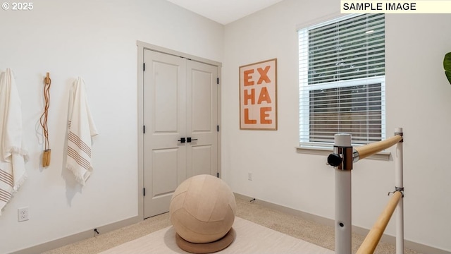 exercise area with carpet floors and baseboards