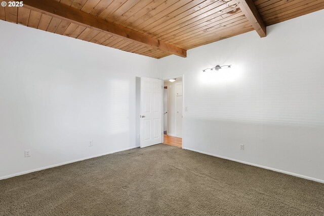 carpeted spare room featuring beamed ceiling, baseboards, and wooden ceiling