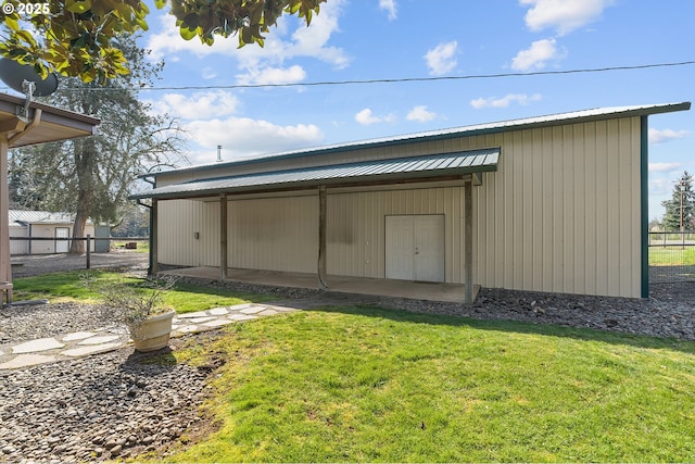 view of pole building with a yard and fence