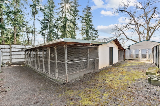 view of outbuilding with an outdoor structure and fence