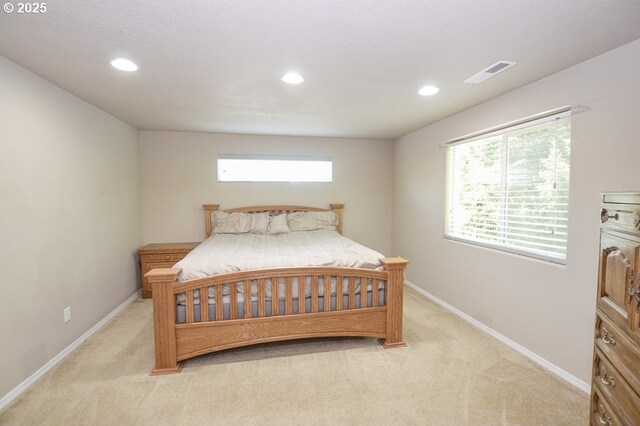 bedroom featuring light carpet, recessed lighting, and baseboards