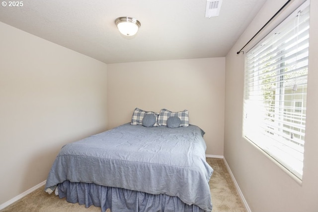 bedroom with carpet floors and baseboards