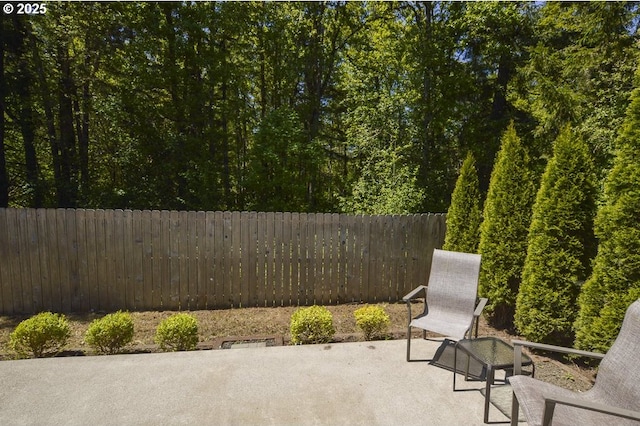 view of patio featuring fence