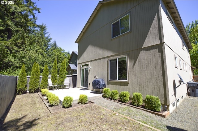 back of property with a patio area and a fenced backyard