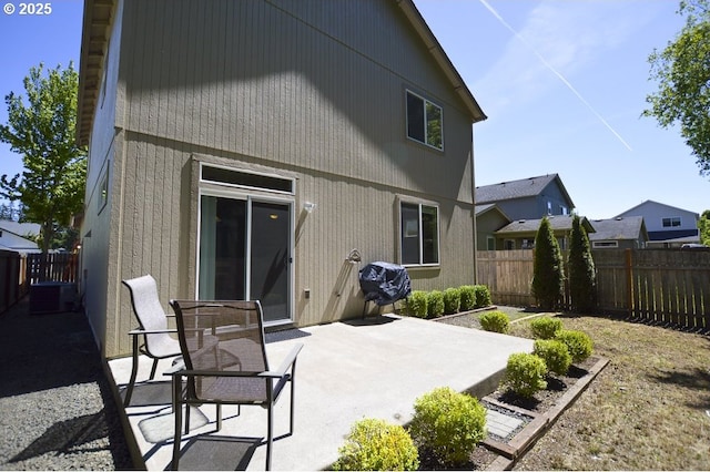 back of property with a patio area and a fenced backyard