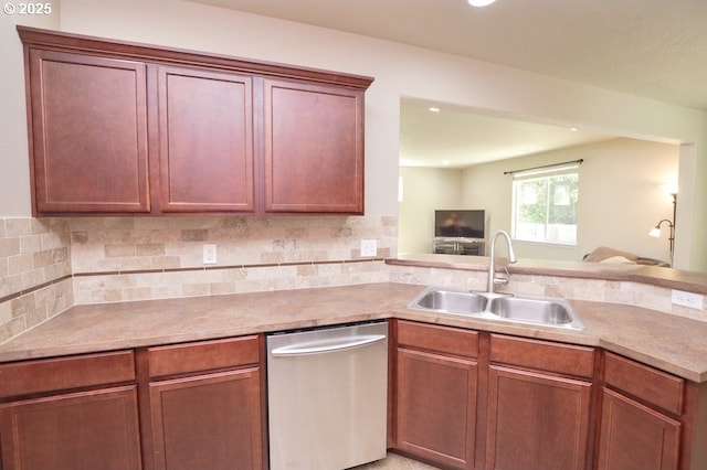 kitchen with dishwasher, a sink, open floor plan, tasteful backsplash, and light countertops