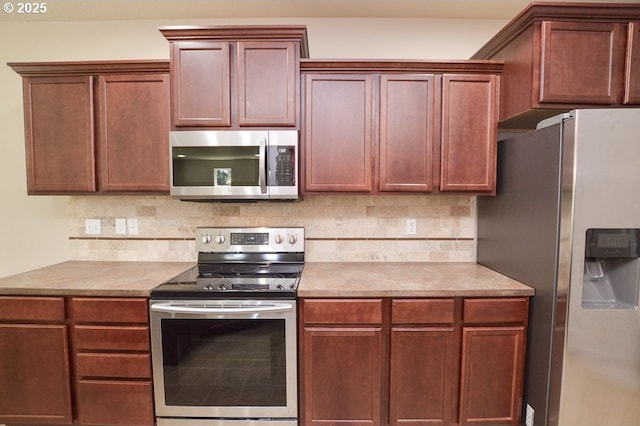 kitchen with appliances with stainless steel finishes, backsplash, and light countertops