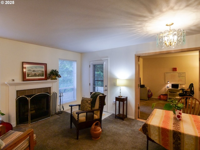 carpeted living room with an inviting chandelier, baseboards, and a tile fireplace