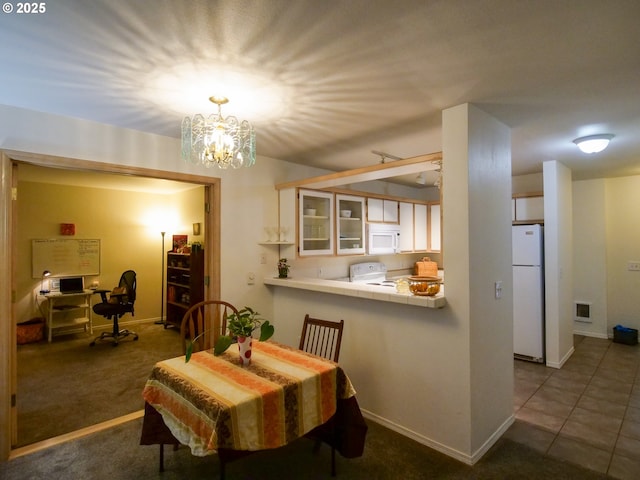 dining room with visible vents, baseboards, a notable chandelier, and carpet