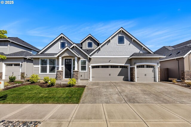 2928 S Harper Valley Way, Ridgefield, WA 98642 - craftsman house with an attached garage, stone siding, a front lawn, and concrete driveway