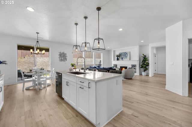 2928 S Harper Valley Way, Ridgefield, WA 98642 - kitchen with a notable chandelier, light countertops, light wood finished floors, dishwasher, and a sink