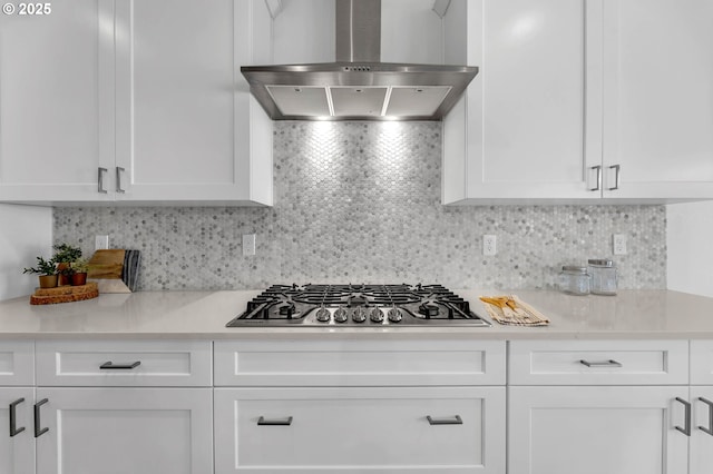 2928 S Harper Valley Way, Ridgefield, WA 98642 - kitchen featuring tasteful backsplash, wall chimney range hood, light countertops, white cabinets, and stainless steel gas stovetop