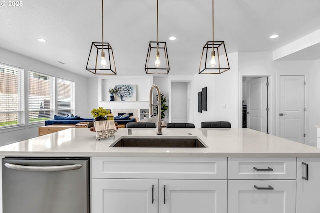 2928 S Harper Valley Way, Ridgefield, WA 98642 - kitchen with white cabinetry, dishwasher, a sink, light countertops, and open floor plan
