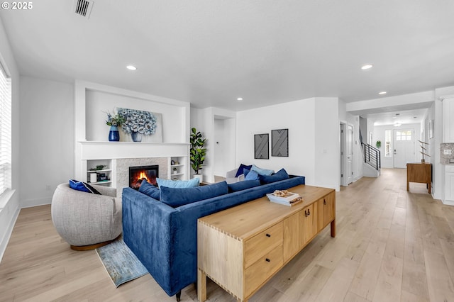 2928 S Harper Valley Way, Ridgefield, WA 98642 - living room featuring recessed lighting, light wood-style flooring, baseboards, and a stone fireplace