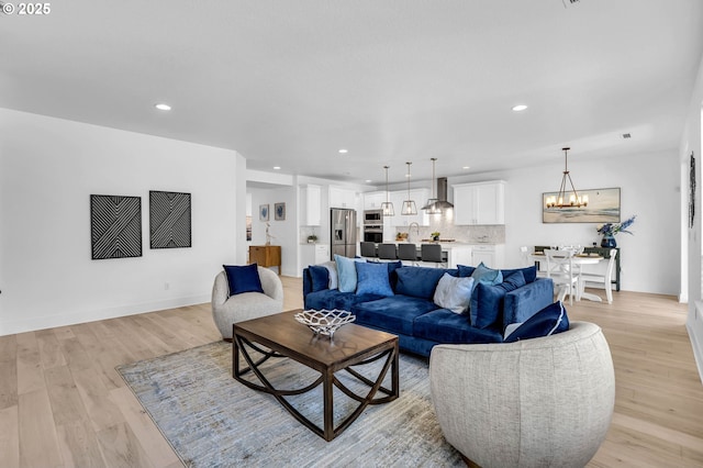 2928 S Harper Valley Way, Ridgefield, WA 98642 - living area featuring light wood finished floors, a notable chandelier, and recessed lighting