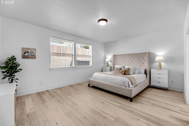 2928 S Harper Valley Way, Ridgefield, WA 98642 - bedroom with light wood-style flooring, baseboards, and a textured ceiling