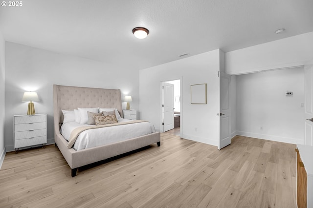 2928 S Harper Valley Way, Ridgefield, WA 98642 - bedroom featuring light wood-style flooring, ensuite bathroom, and baseboards