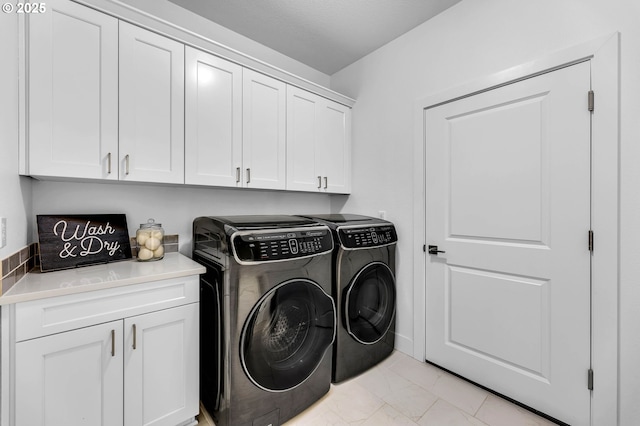 2928 S Harper Valley Way, Ridgefield, WA 98642 - laundry area featuring cabinet space, washing machine and clothes dryer, and marble finish floor