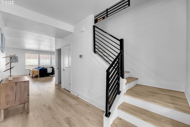 2928 S Harper Valley Way, Ridgefield, WA 98642 - stairs featuring baseboards, wood finished floors, and a textured ceiling